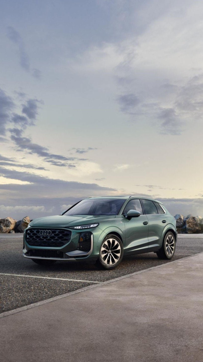 Left side profile view of an Audi Q5 parked.
