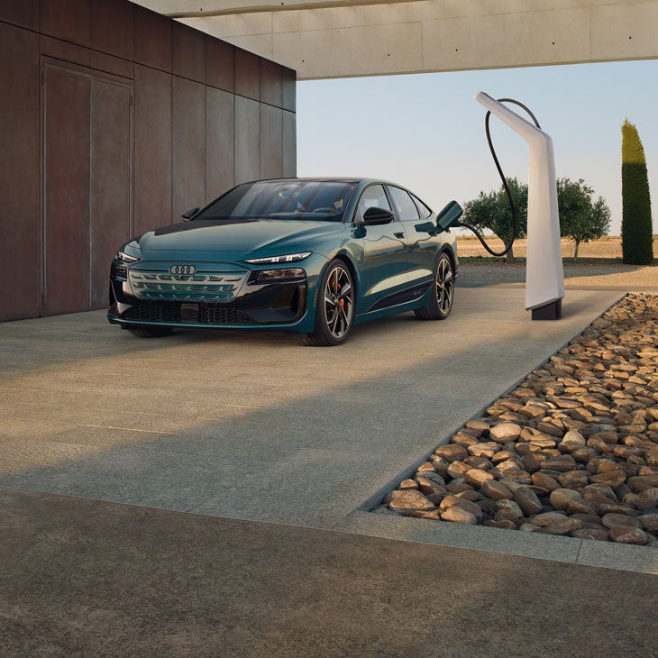 Three-quarter front view of the Audi S6 Sportback e-tron charging.