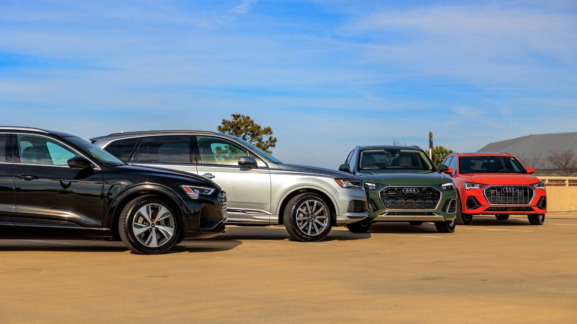 Four Audi vehicles parked.