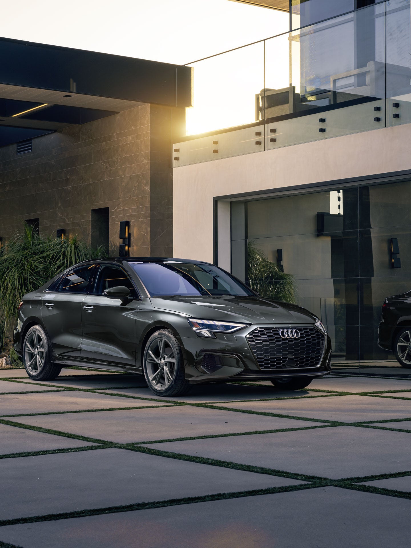 The Audi A3 parked in front of a modern house.