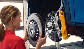 Service technician serving vehicle.