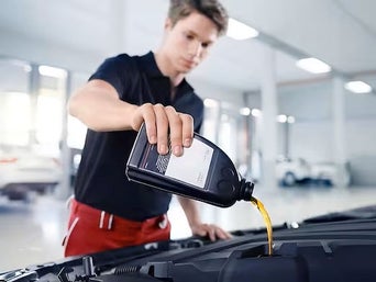 Service technician serving vehicle.