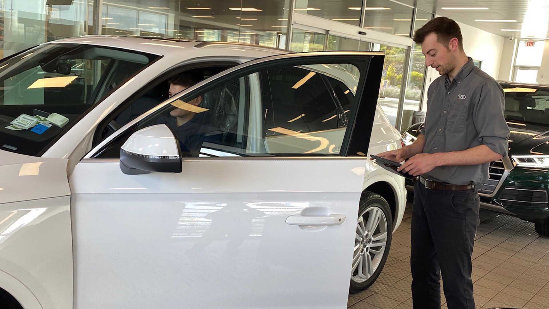 Audi service technician servicing a vehicle.