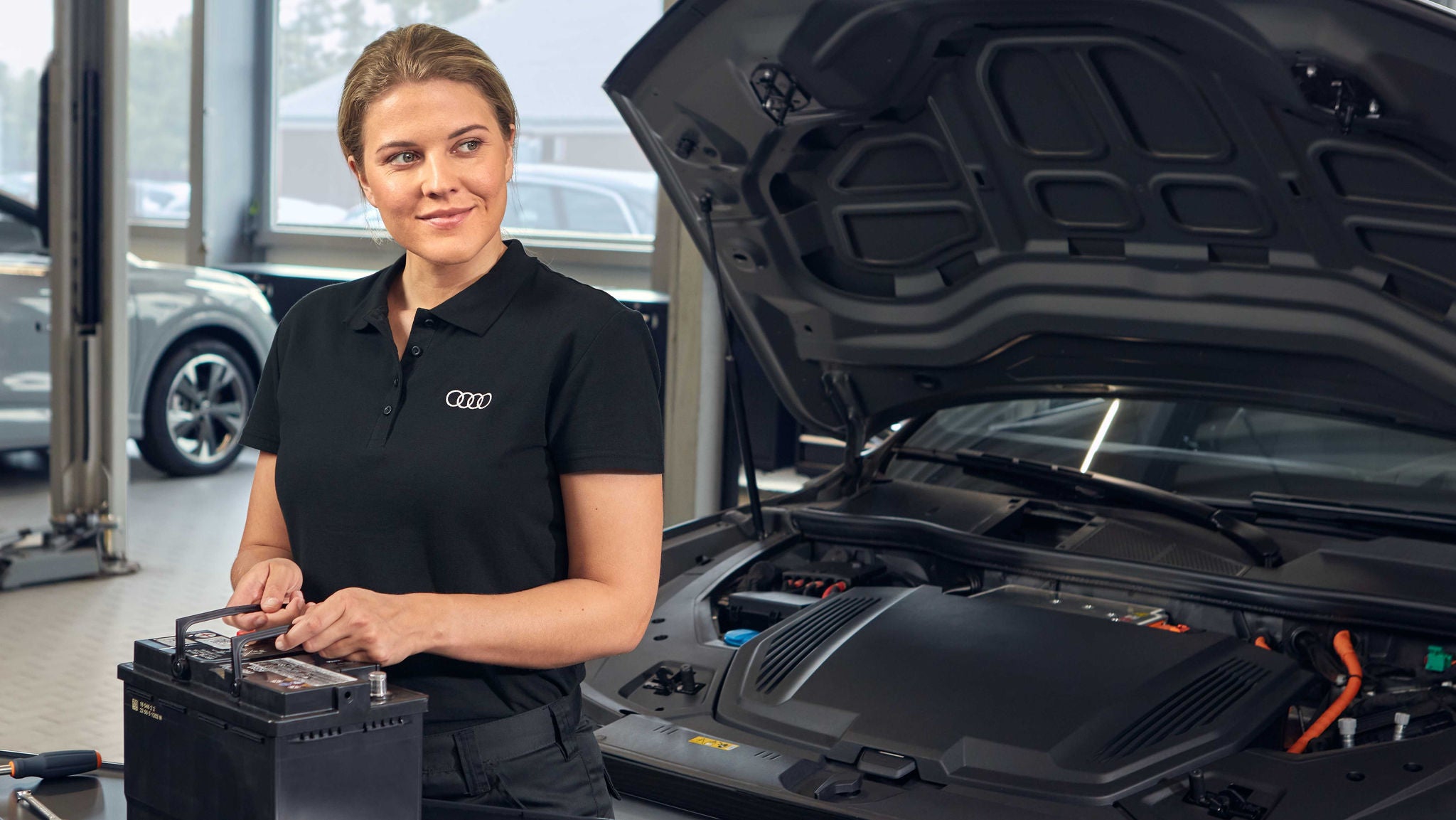 Audi service technician servicing a vehicle.
