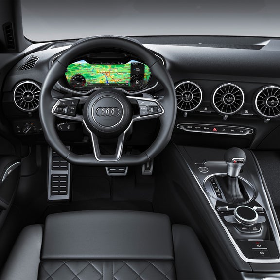 Interior shot of the drivers cockpit of an Audi TT vehicle.