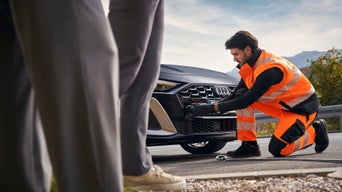 Audi technician roadside assitance with an A5