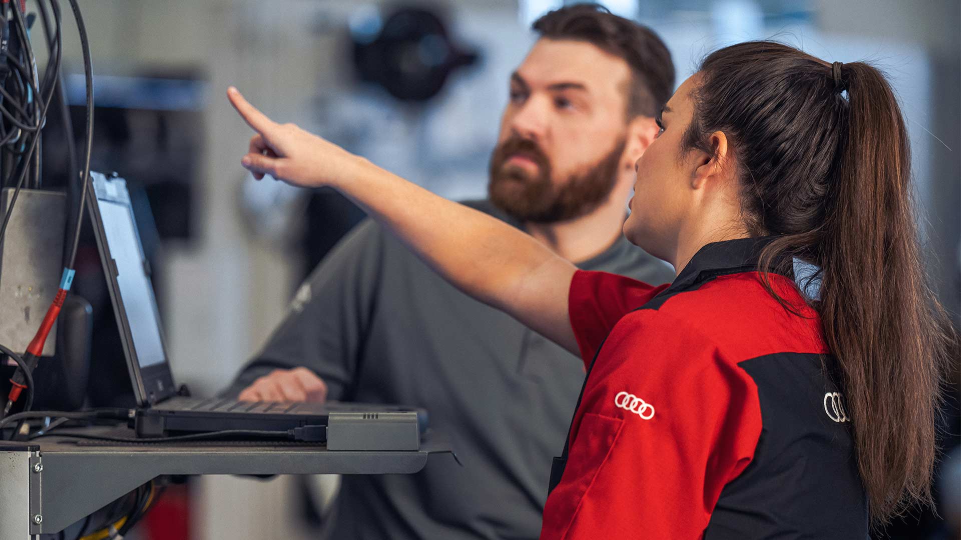 Service technician inspecting vehicle.