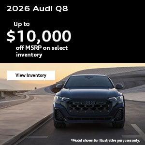 Side view of an Audi Q7 driving.