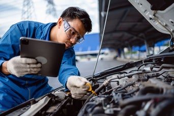 An Audi technician servicing a vehicle