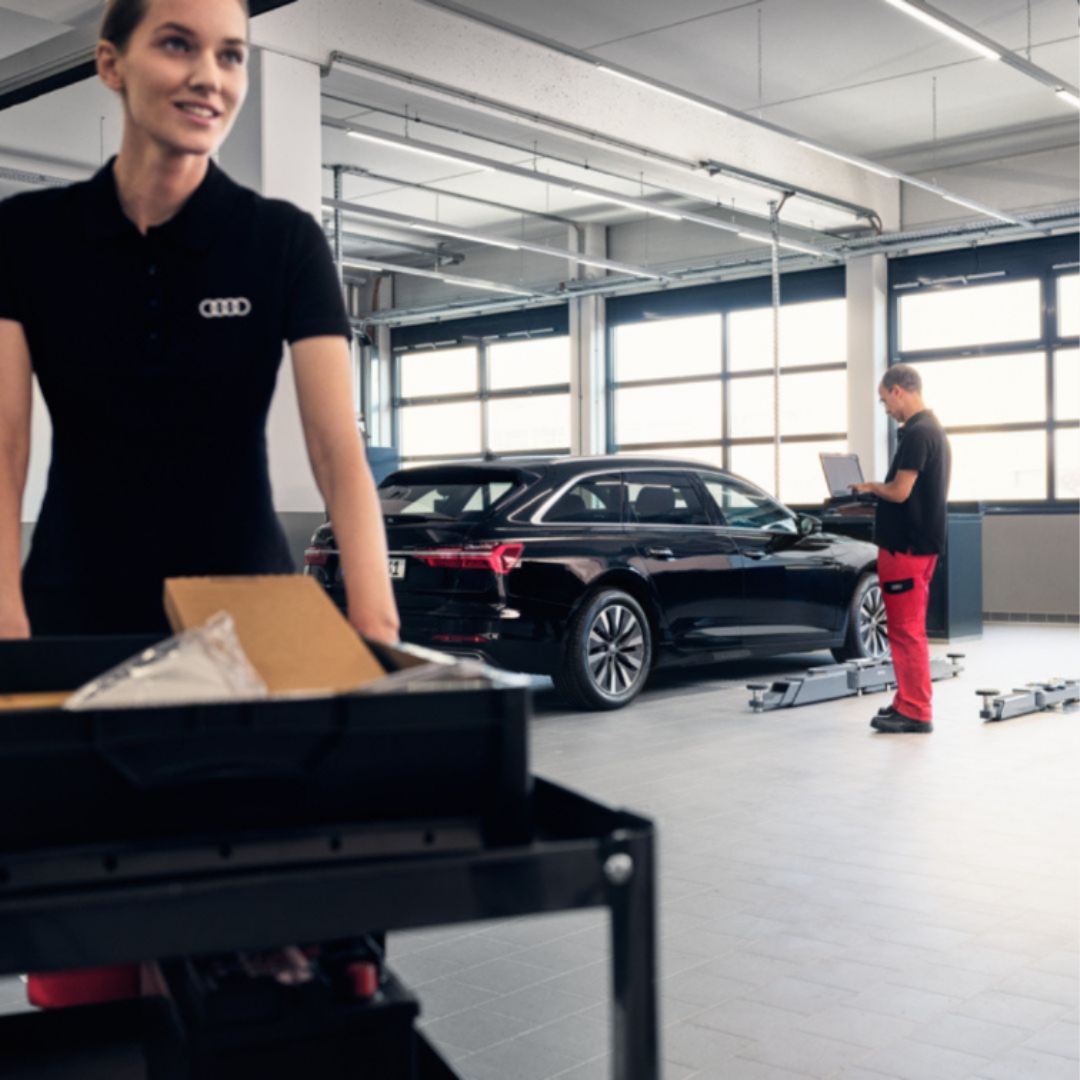 Image of audi tech working on a car