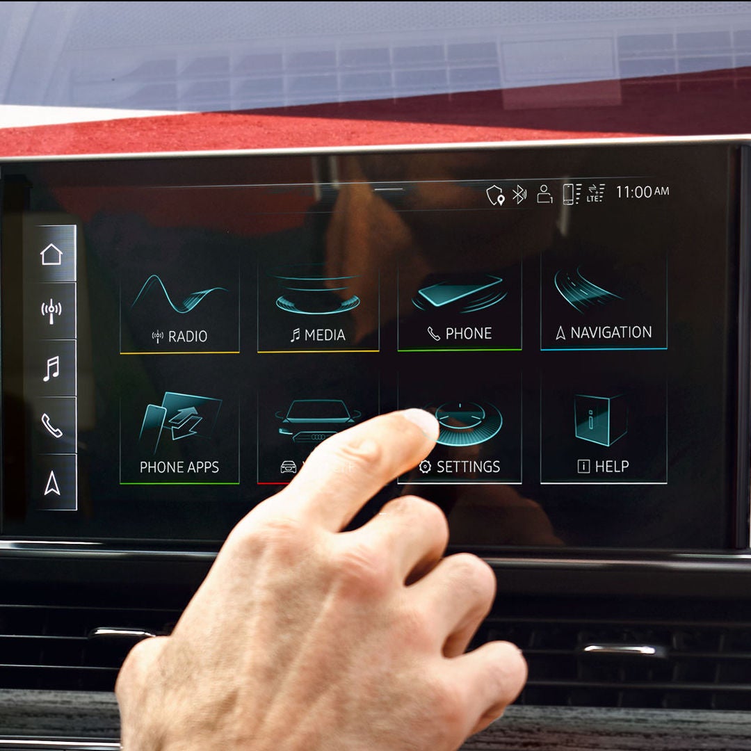 Close-up of a person navigating the MMI touch display in their Audi.