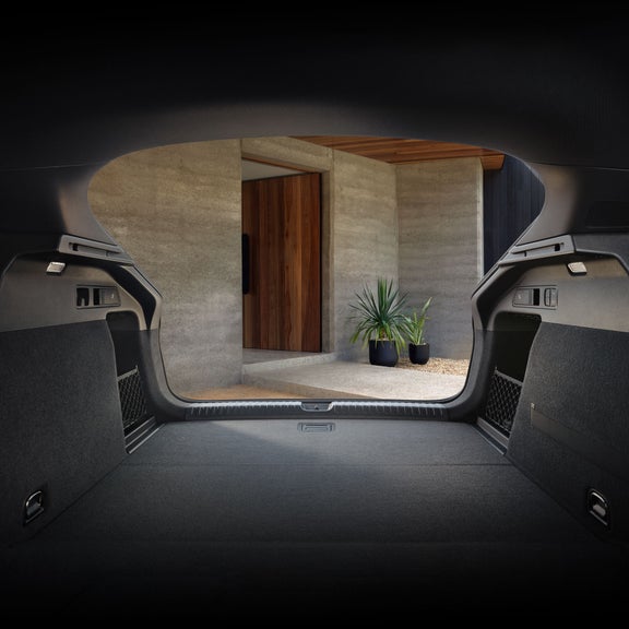 Interior view of the split-folding seats and open trunk of the Audi Q6 Sportback e-tron.
