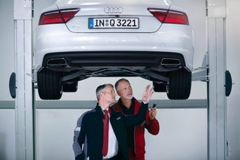 Service technicians servicing vehicle.
