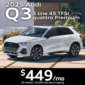 Side view of an Audi Q3 driving.