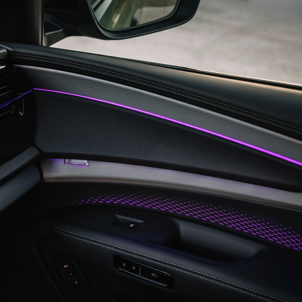 Close-up on the door sill of an Audi vehicle, showing the interior lighting features.