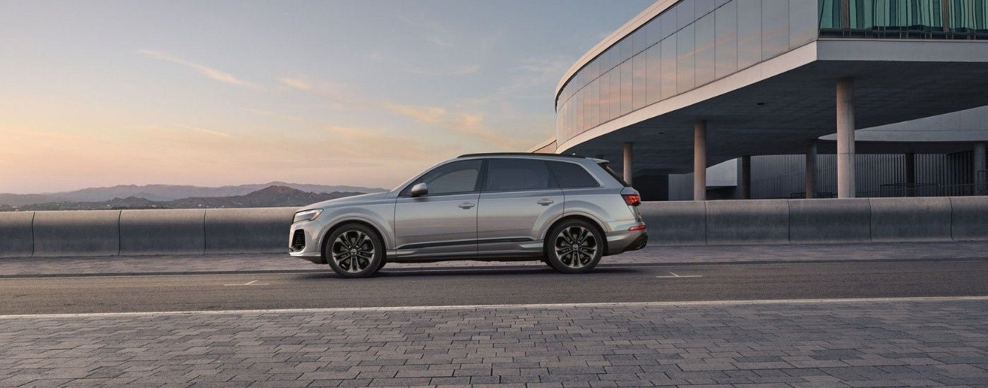 New 2025 Audi Q7 side view on a bridge