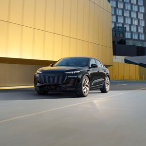 Three-quarter view of the Audi SQ6 Sportback e-tron accelerating.