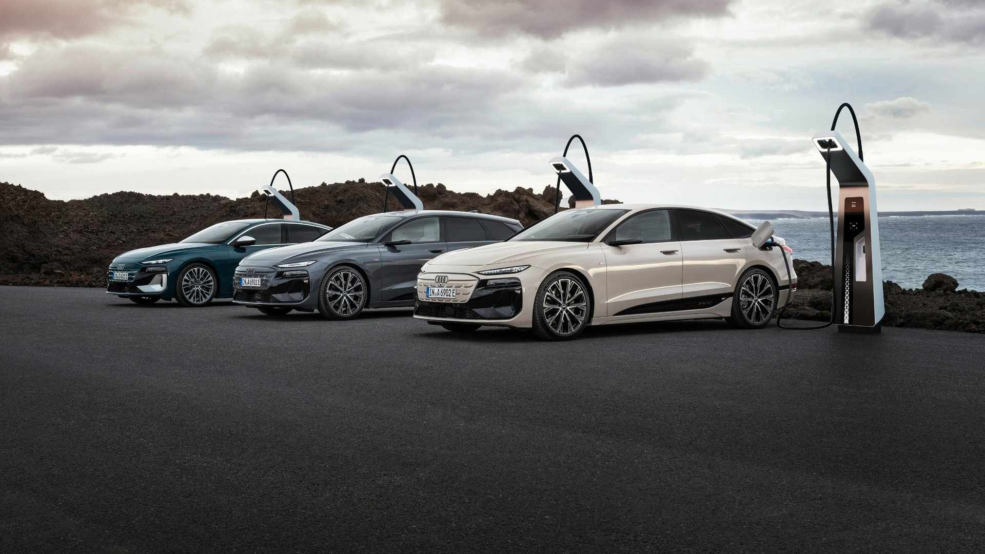 Left profile view of 4 audi electric vehicles parked and charging.