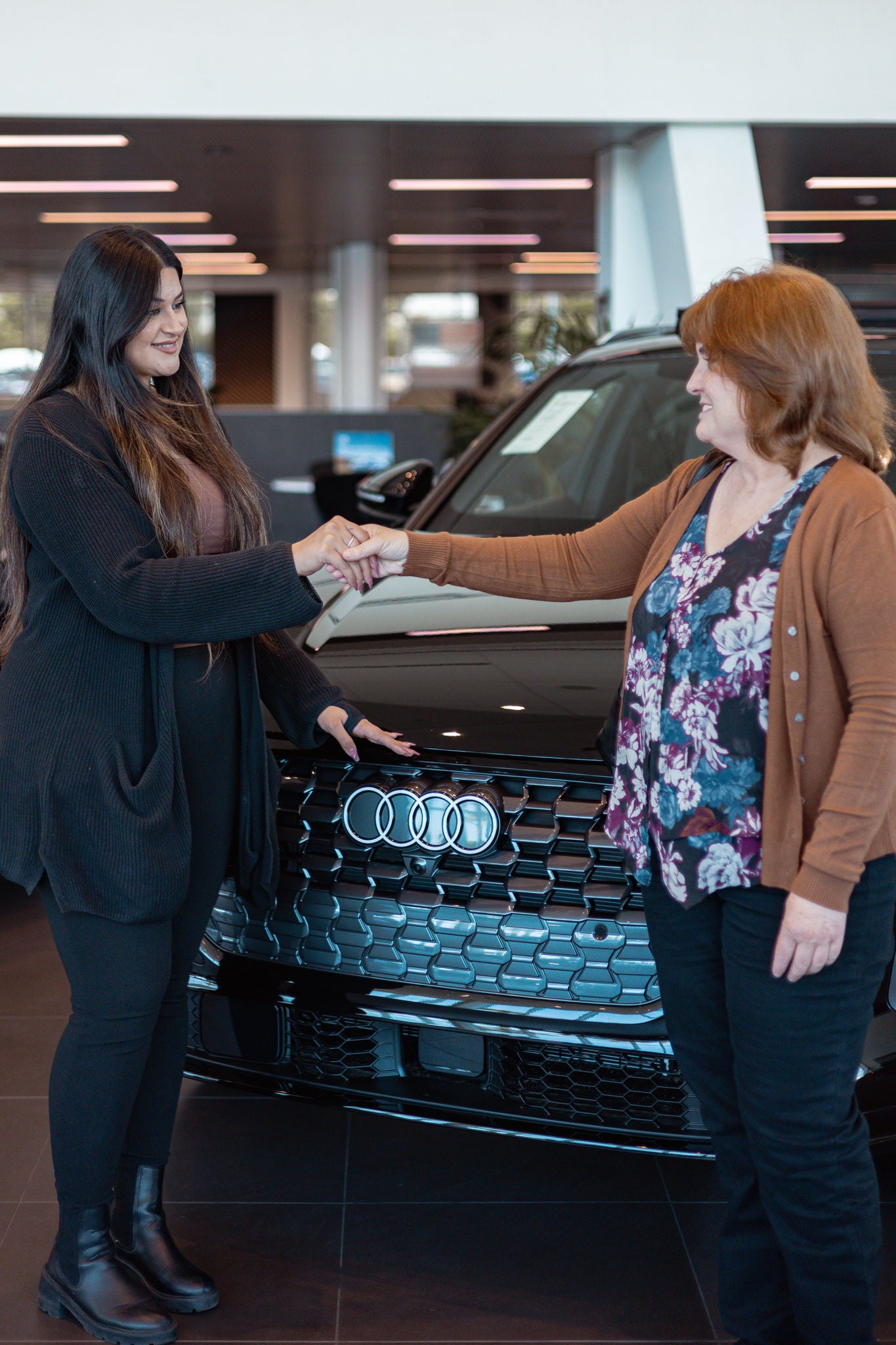 Audi Sale Specialist with a customer in the showroom.