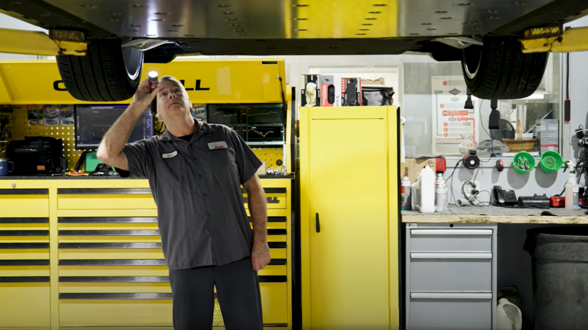 Mechanic inspecting a vehicle.