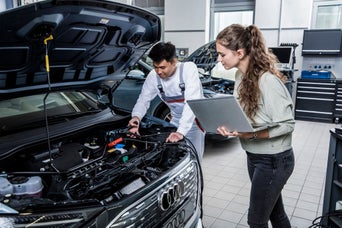 Service technicians serving vehicle. 