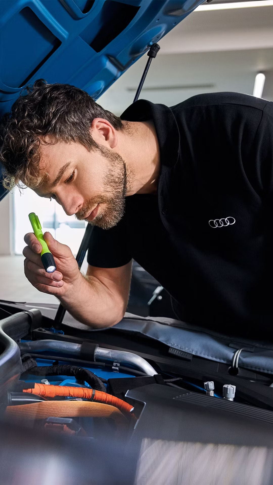 Audi Service tech looking at an engine