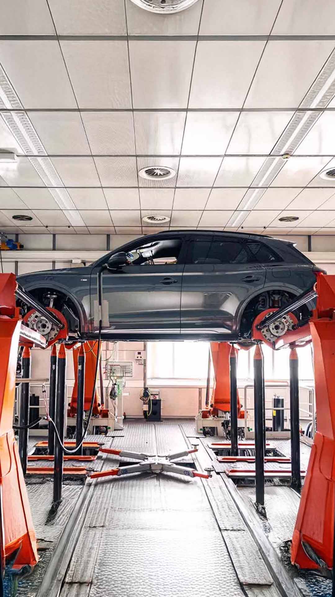 Side profile view of an Audi Q5 vehicle being serviced.