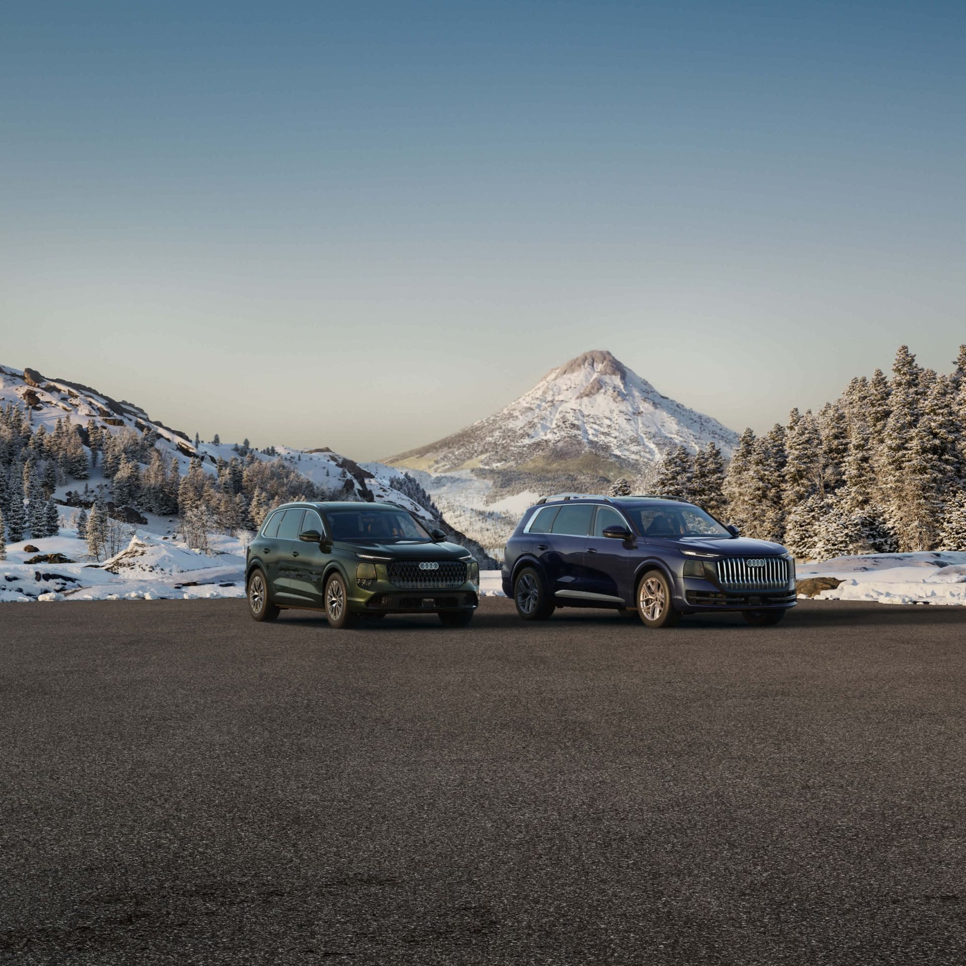 Front profile view of an Audi Q7 and Audi Q9 parked side by side.