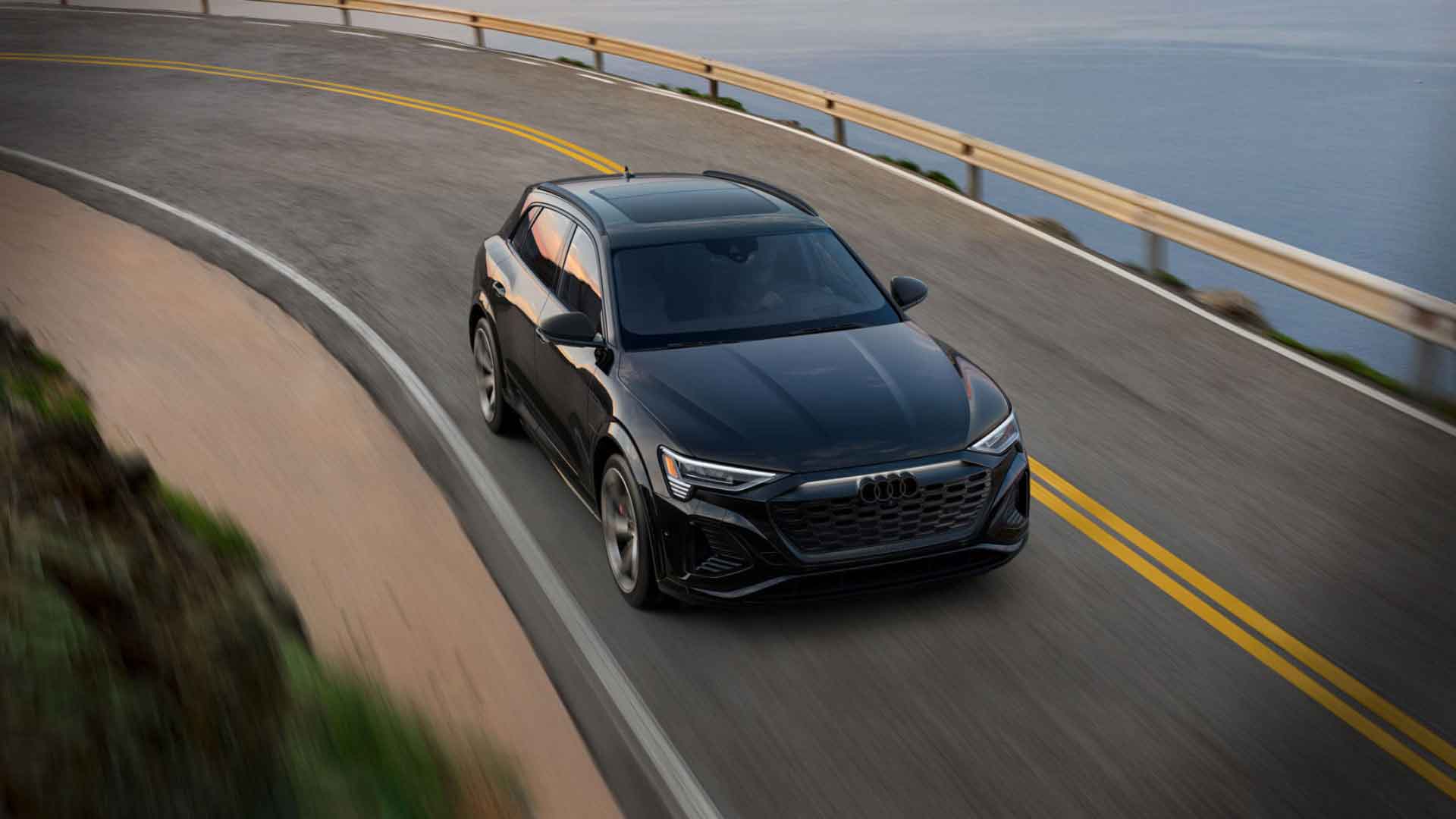 Side view of an Audi Q8 Hybrid driving.