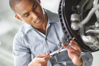 Service technician serving brakes.