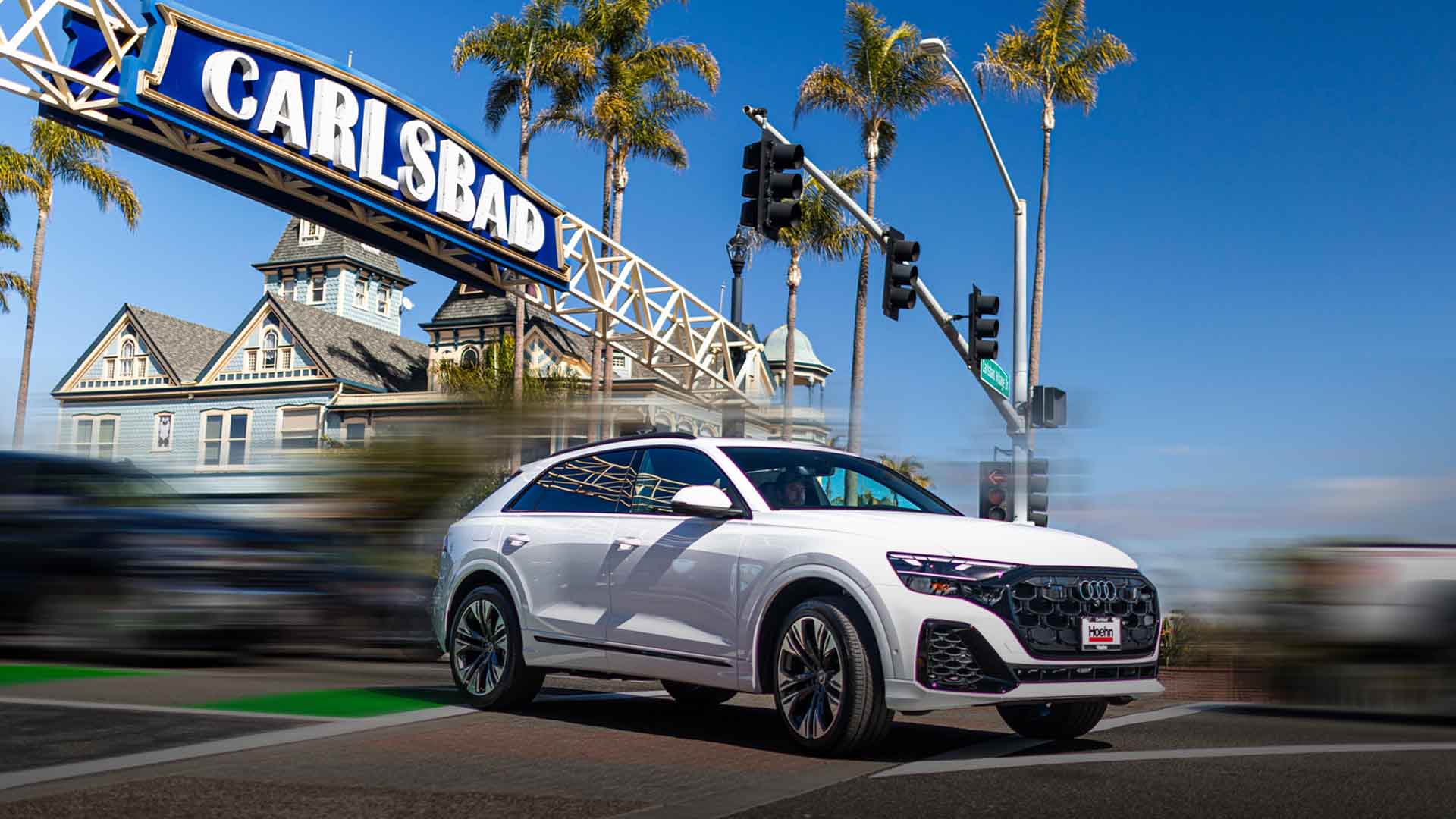 Side profile view of an Audi vehicle on a beach.