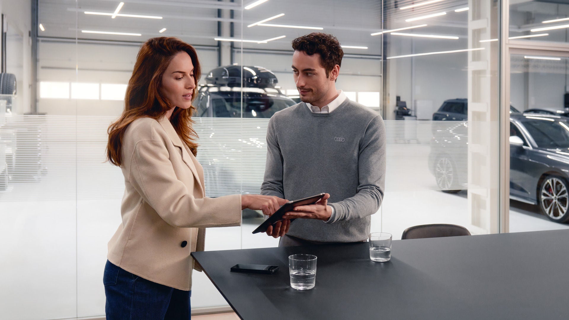 Audi employee helping a customer access his finance account.