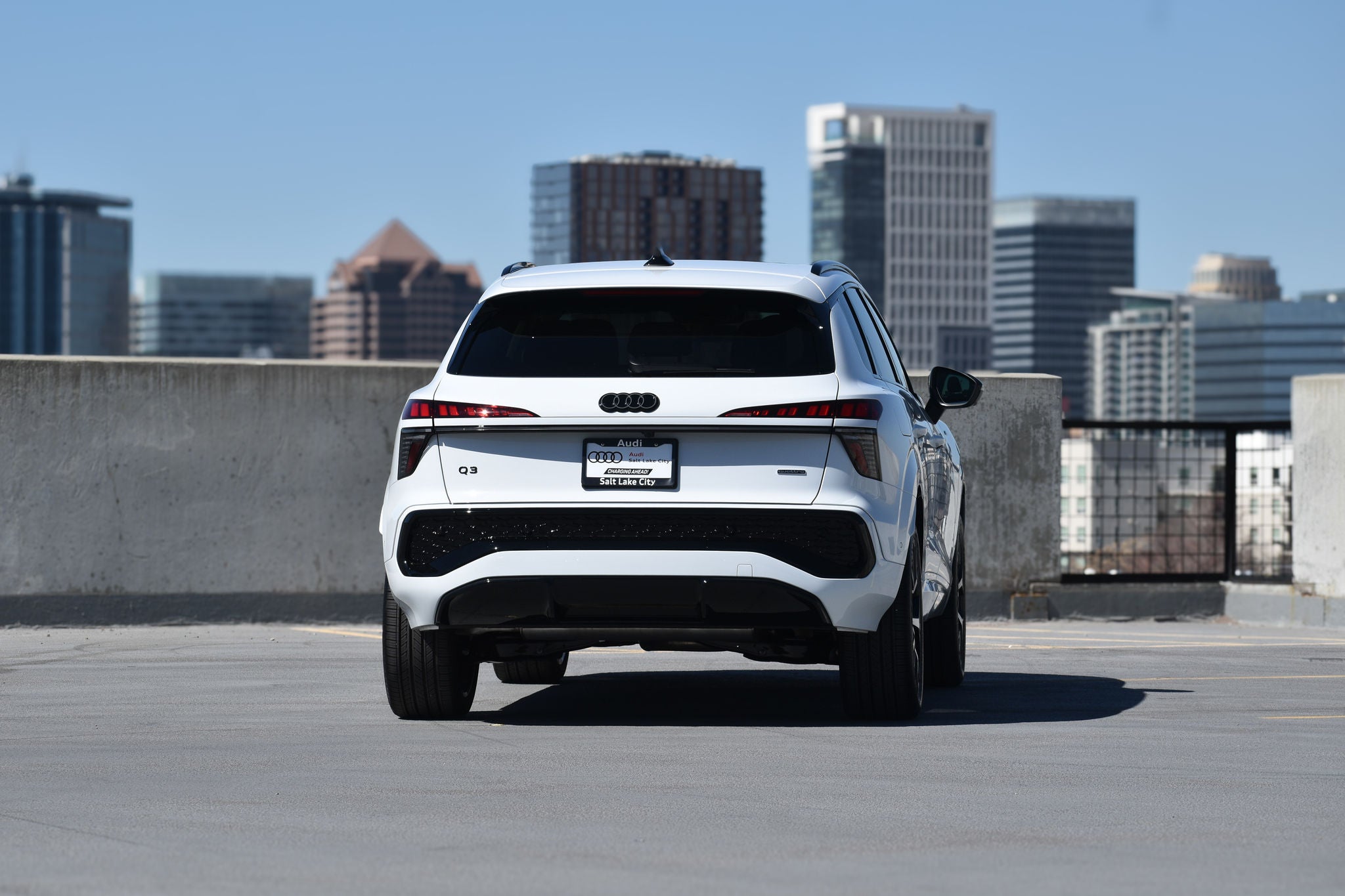 Side profile view of a parked Audi Q3. 