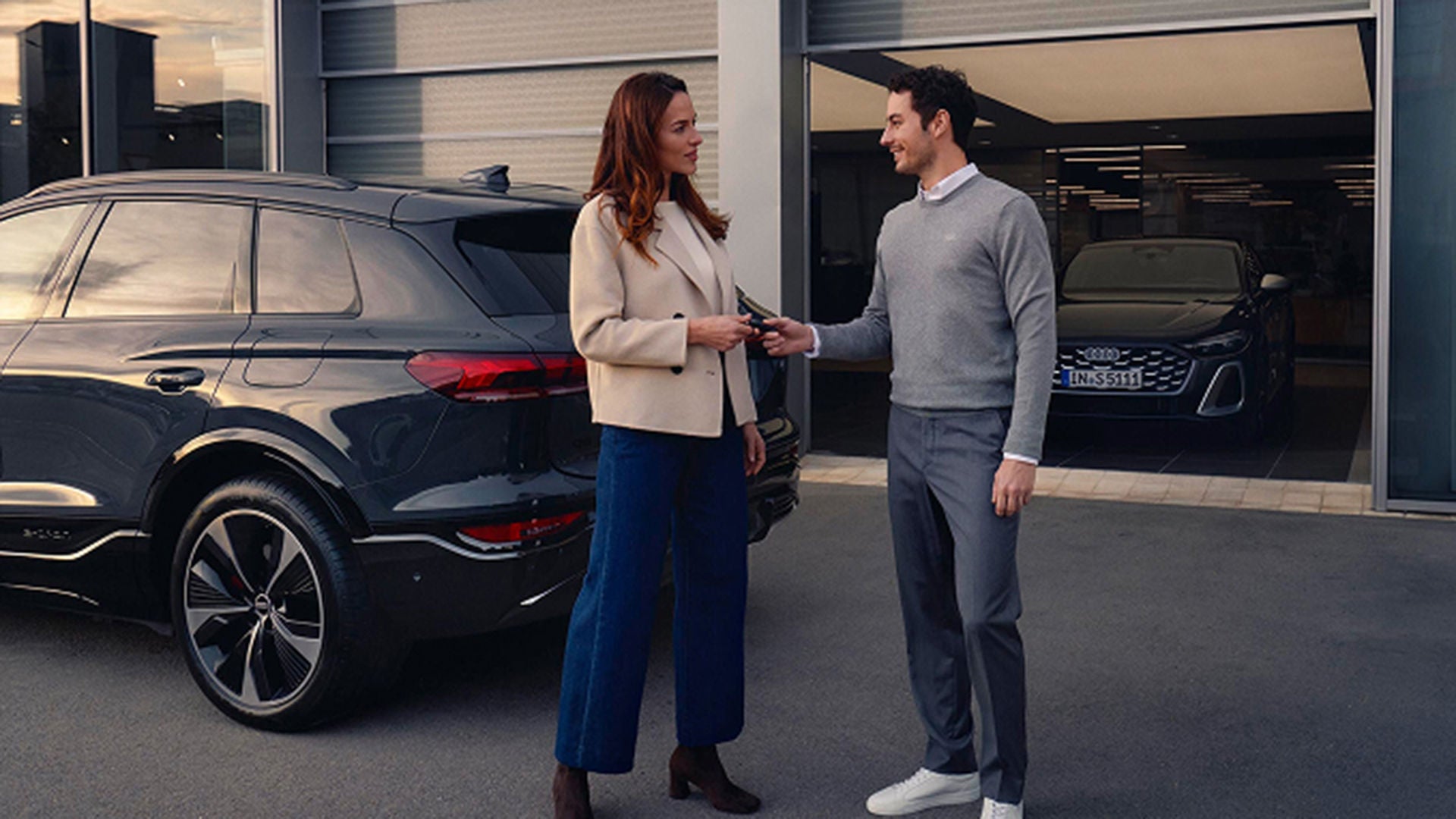 Audi employee assisting a customer.