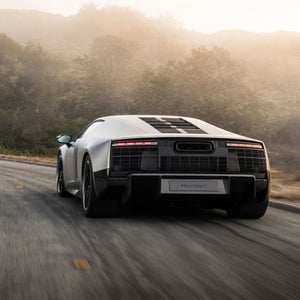 Rear-view of the Audi Nuvolari accelerating on a countryside road.