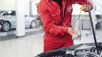 Service technician servicing vehicle.