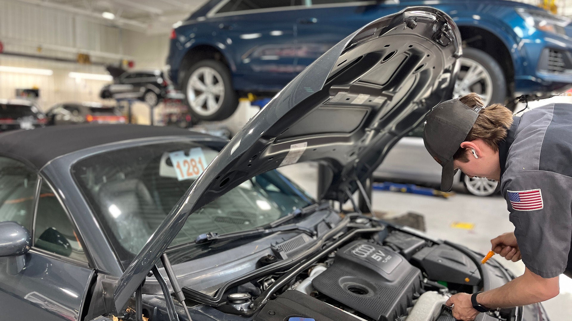 Audi service technician servicing a vehicle.