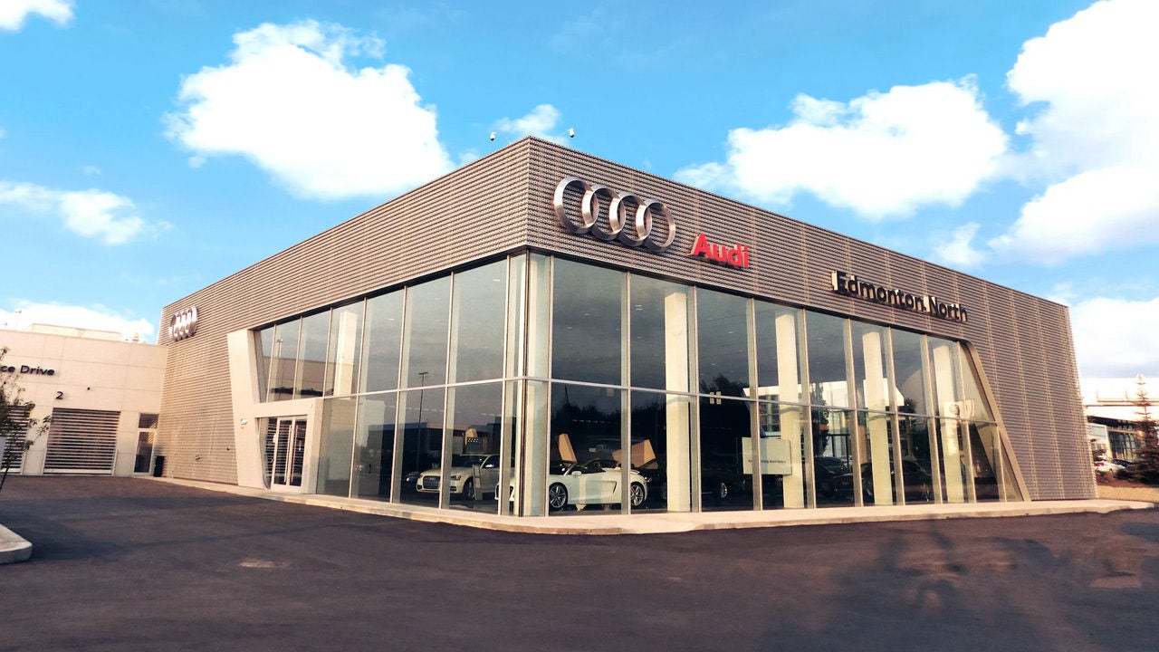 Audi Sale Specialist walking through the showroom with a couple.