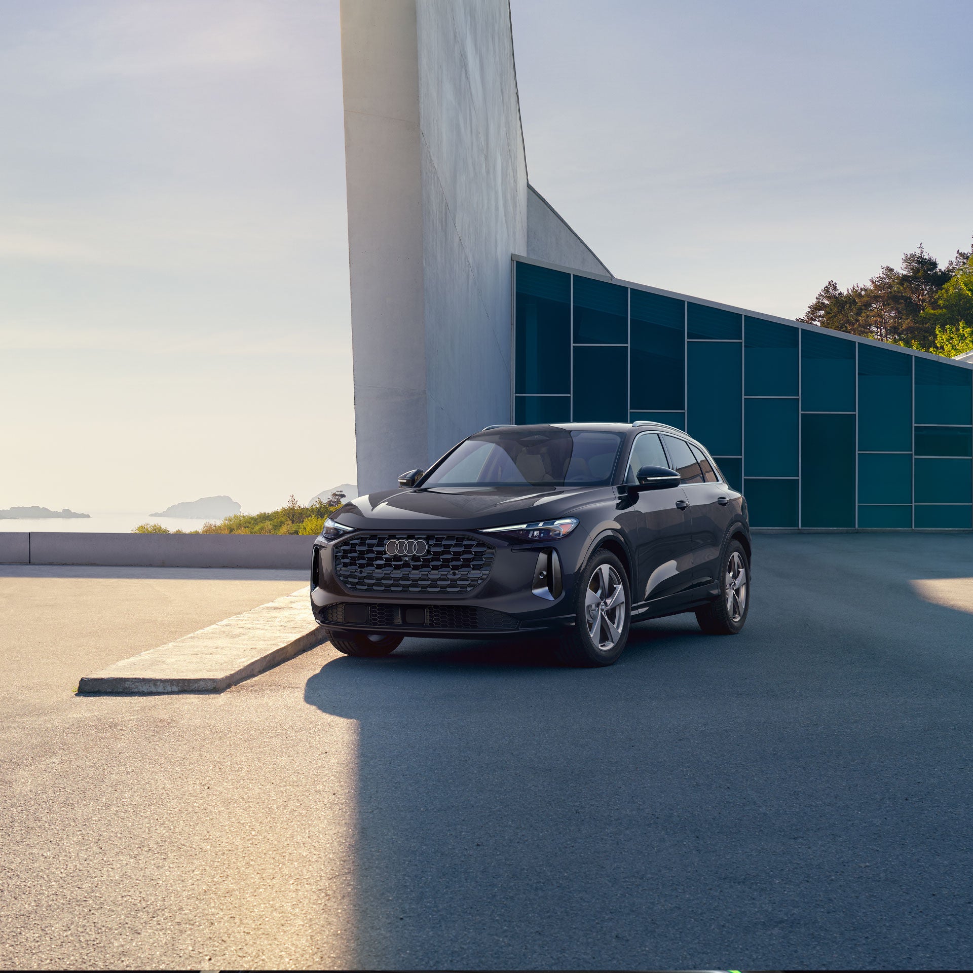 Three-quarter side profile of an Audi A6 accelerating.