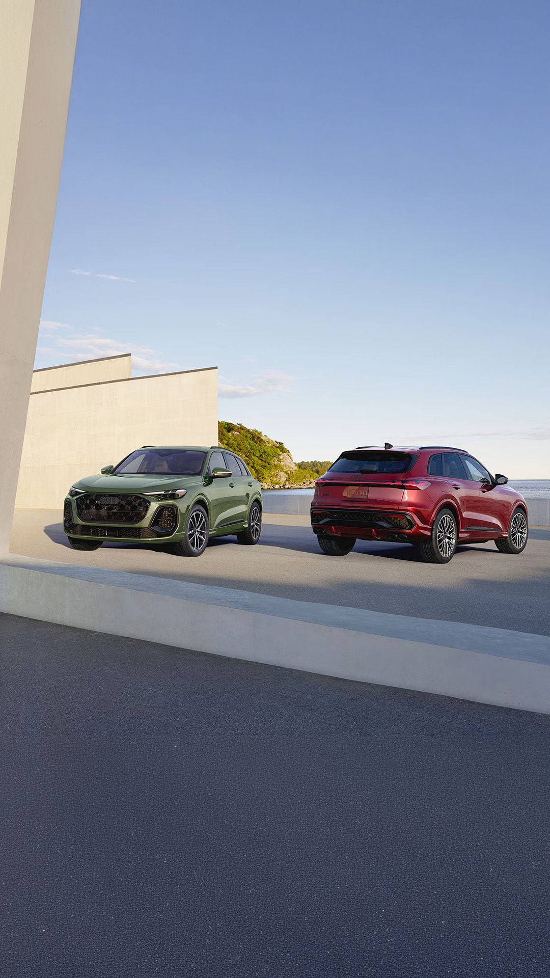 Two Audi SUV's parked outside