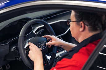 Service technician serving vehicle.