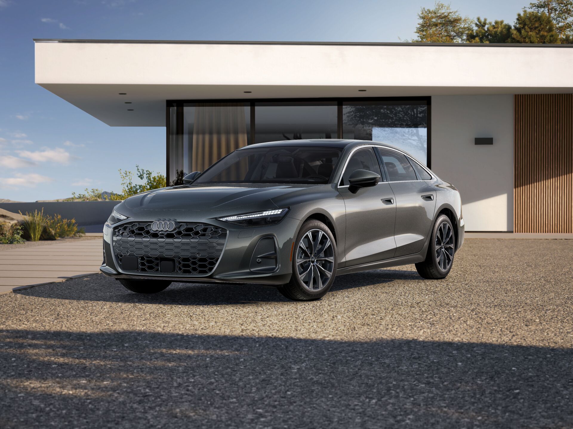 2026 Audi A6 Premium Plus trim level im grey paked in front of modern house