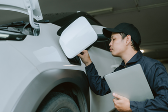 Service technician servicing vehicle.