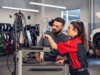 Service technician serving vehicle.