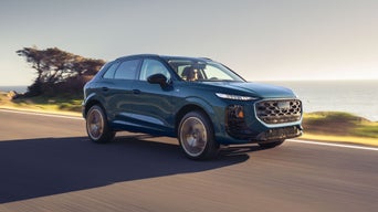 Three-quarter front view of the Audi Q3 driving on the highway.