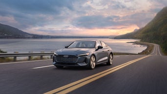 Front view of the Audi A5 accelerating on an oceanside road.