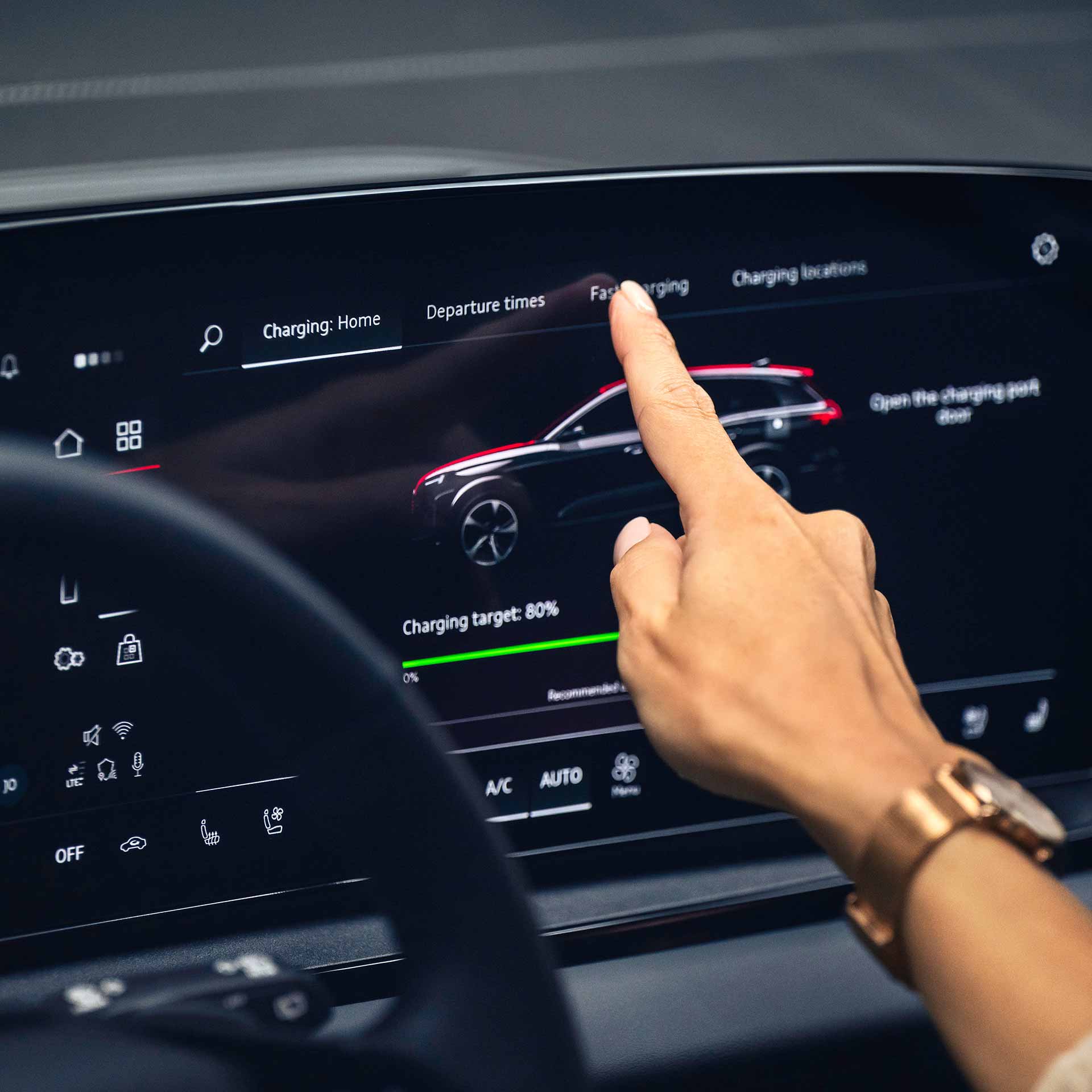 A red Audi A7 driving under a highway overpass.