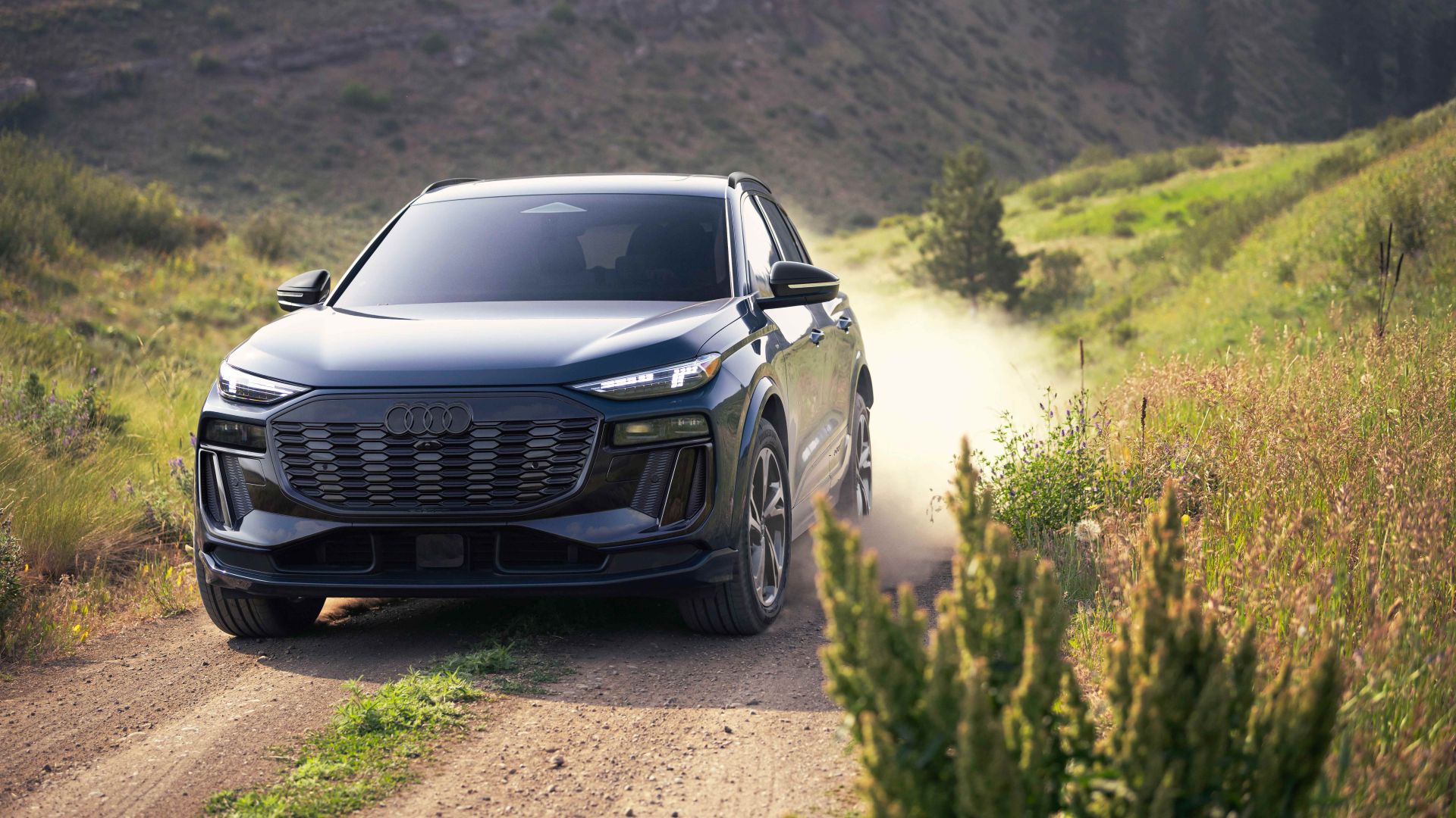 Front profile view of an Audi Q6 etron accelerating.