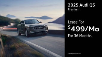 Three quarter view of an Audi Q5 driving.