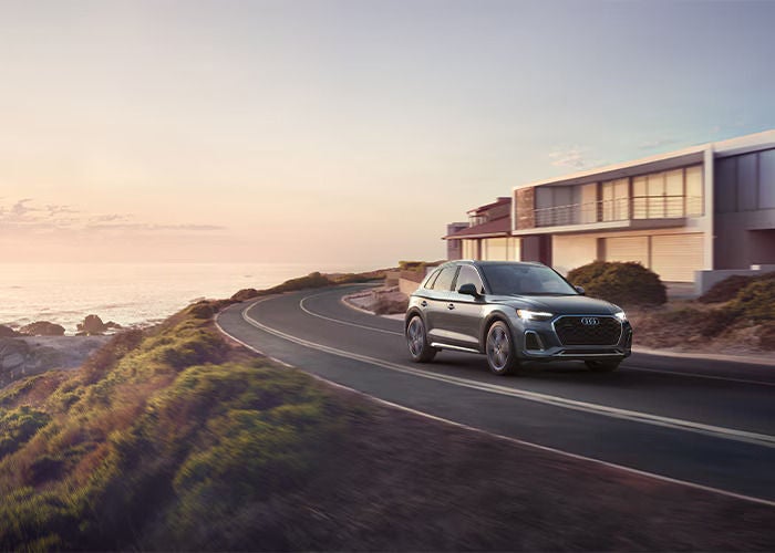 New Audi Q5 drive through a banked road.
